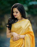 RK Collectives yellow litchi silk Banarasi-style jacquard saree worn by a woman with gold jewelry and dark hair